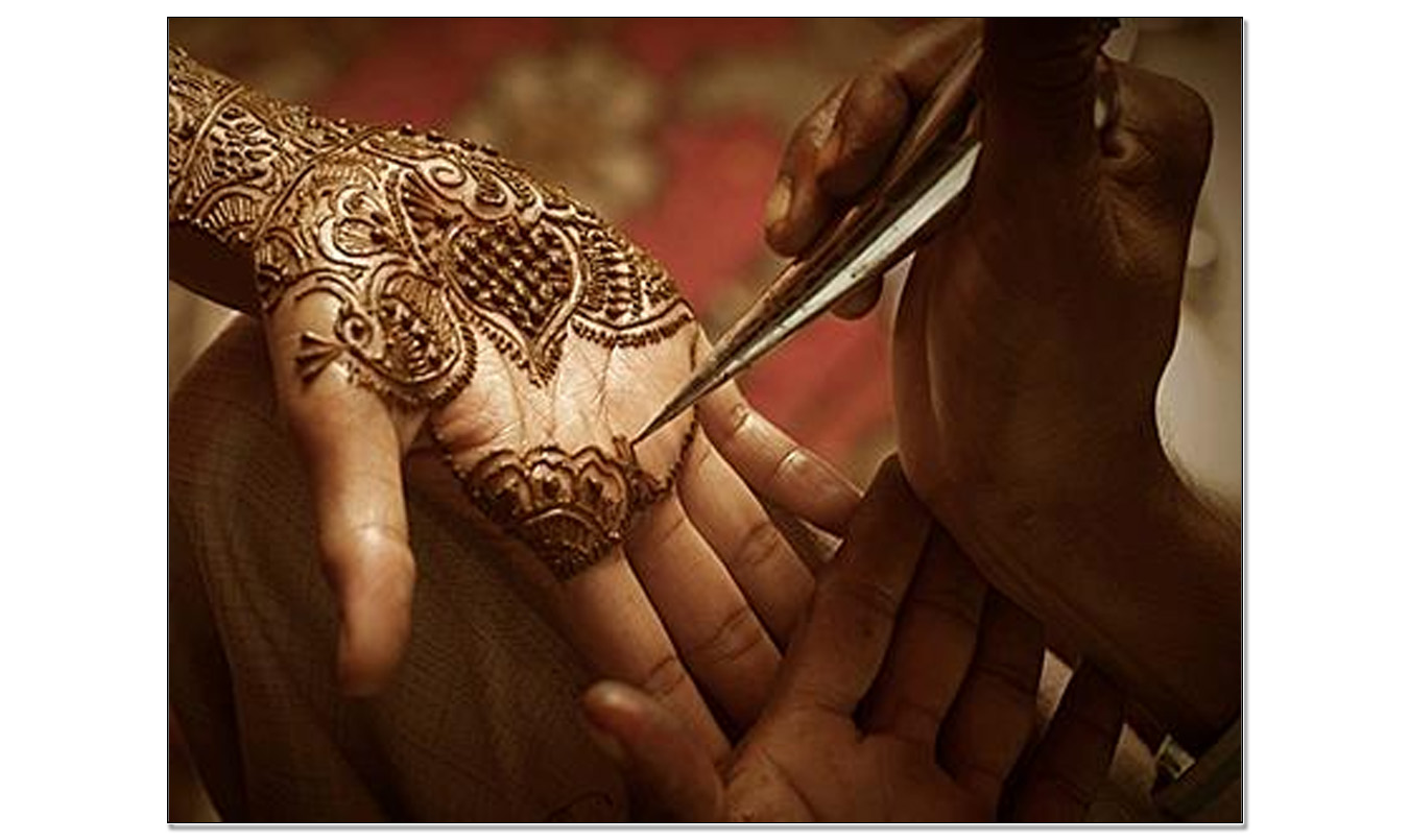 Traditional Mehndi tattoo being applied